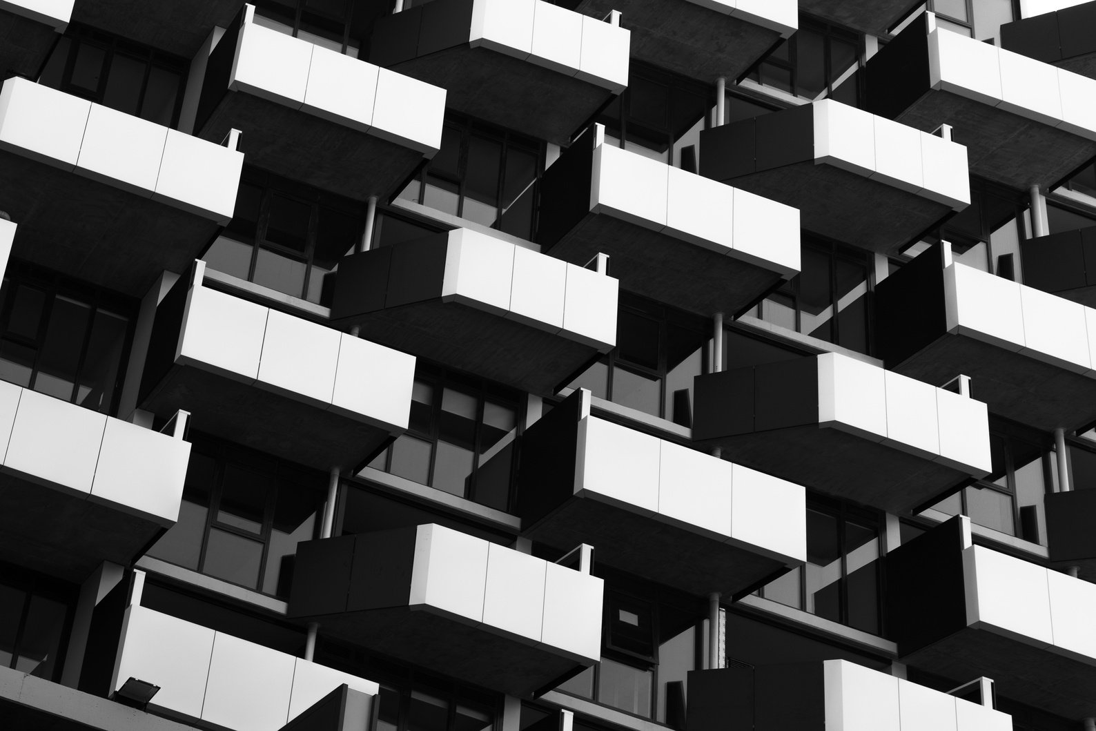 Grayscale Photo of Apartment Balconies