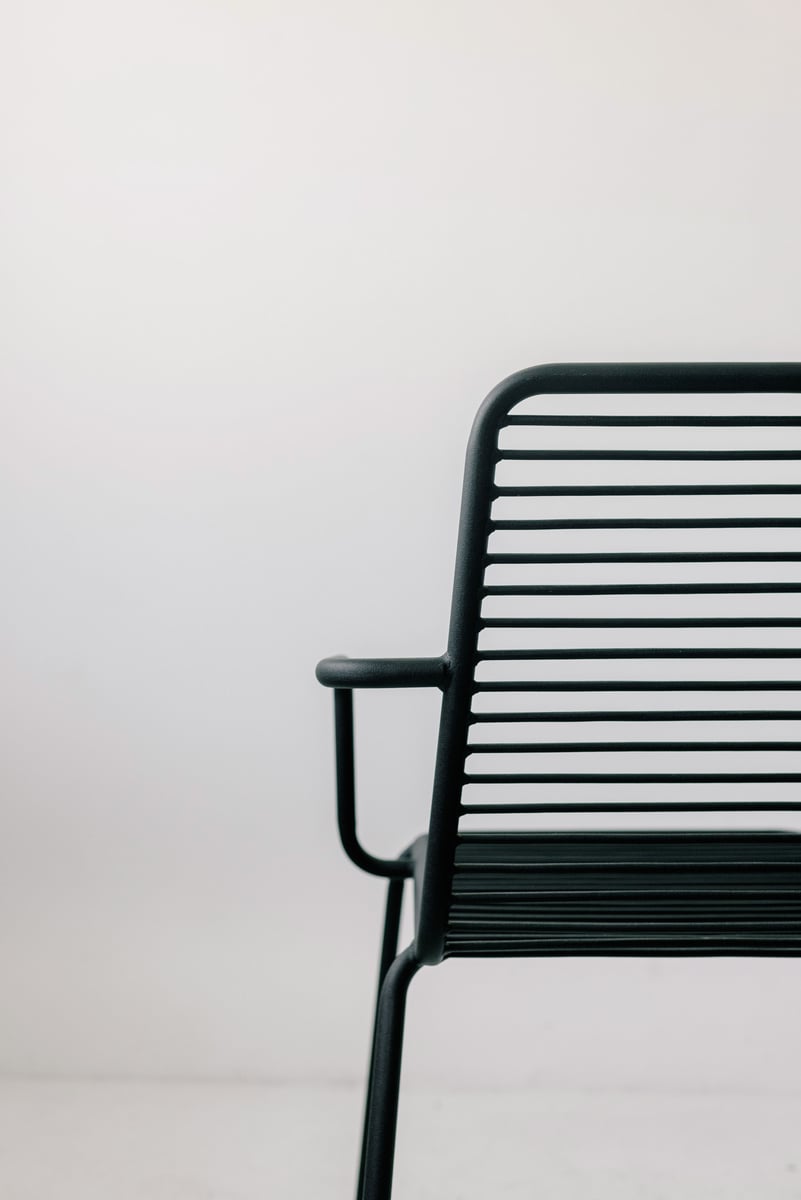A Black Metal Chair on a White Surface